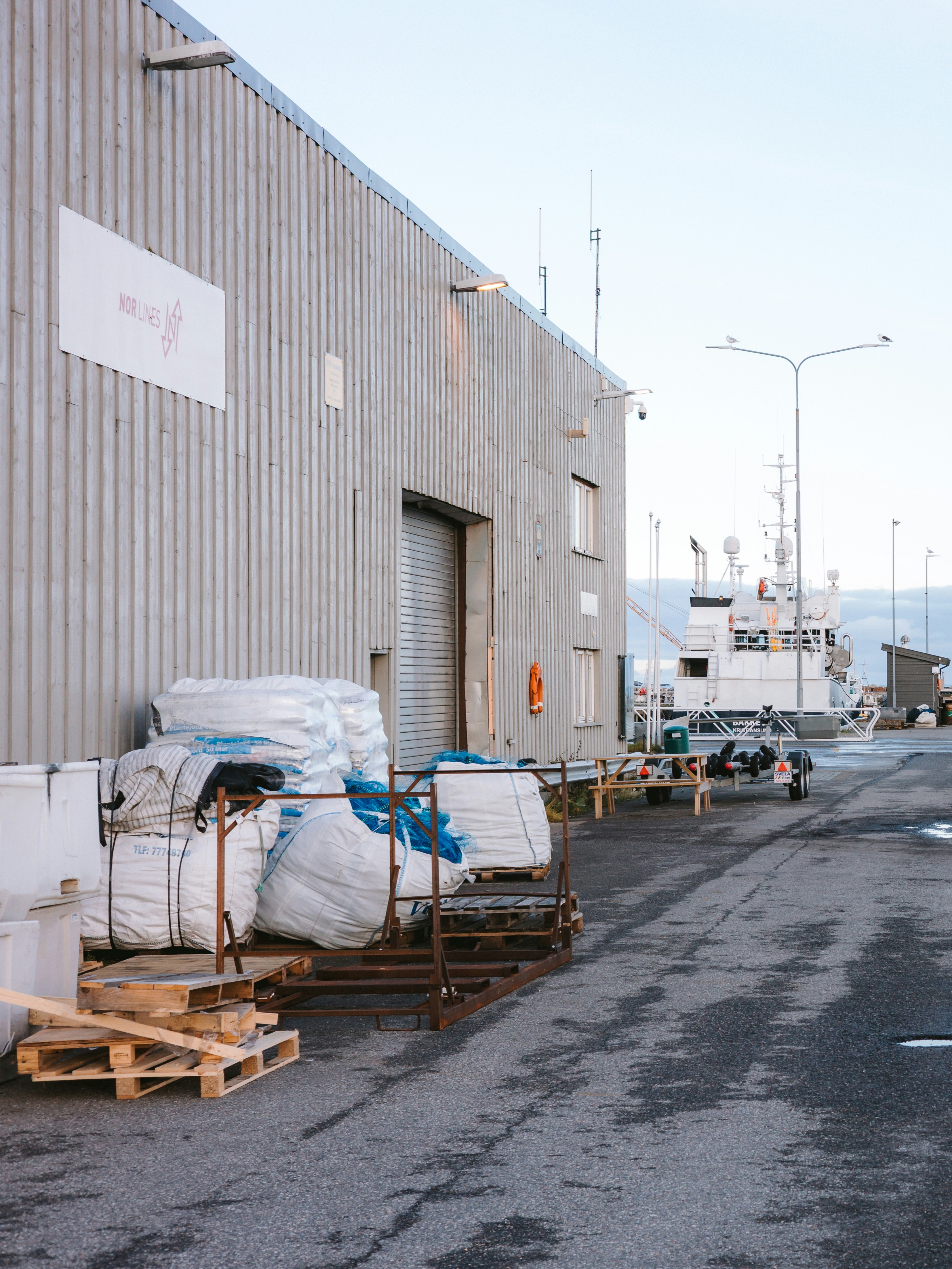 A working harbor beside a corrugated warehouse